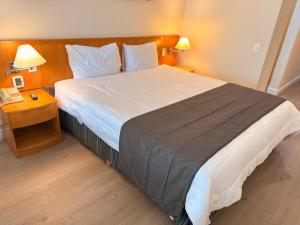 a bedroom with a large bed in a hotel room at Hotel & Residence Alphaville in Barueri +13 photos