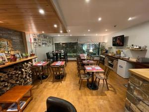 a restaurant with tables and chairs in a room at Hotel Les Truites Adults only in Pas de la Casa