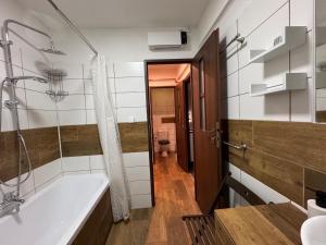 a bathroom with a tub and a sink and a toilet at Ubytování Resslova in Ústí nad Labem +12 photos
