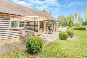 a patio with an umbrella and a table and chairs at 2 Bed in Little Hereford oc-l29580 in Berrington