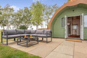 a couch on a patio in front of a green house at 1 Bed in Langtoft oc-l32679 in Langtoft