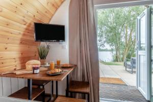 a room with a table and a tv on a wall at 1 Bed in Langtoft oc-l32679 in Langtoft +12 photos
