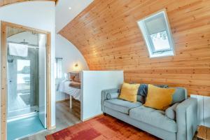 a living room with a couch and wooden walls at 1 Bed in Langtoft oc-l32679 in Langtoft