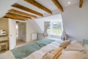 a bedroom with a large bed and a window at 3 Bed in Comrie oc-e33307 in Comrie