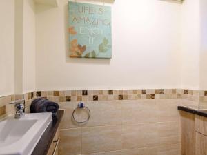 a bathroom with a sink and a mirror and a wall at 4 Bed in Bakewell oc-pk911 in Bakewell +21 photos