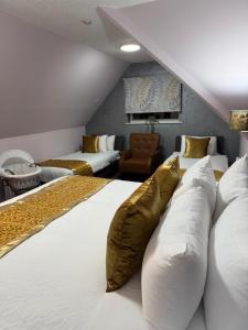 a bedroom with two beds with pillows at Quality City Hotel Restaurant Free Parking in Upton Warren