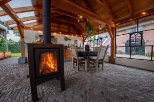 a fireplace in a patio with a table and chairs at B&B Oud-Zilven Het Vogelhuisje in Loenen
