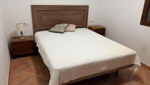 a bed in a room with a white mattress and two night stands at House Lago Azul in Cuevas del Almanzora +18 photos