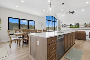 an open kitchen and dining room with a table and chairs at Modern Lakefront Escape | The Twelve in Camdenton
