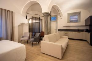 a bedroom with a bed and a living room at Ca Moroni Collection in Bergamo