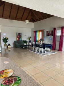 a living room with a couch and a table and chairs at Penthouse villa in Montego Bay