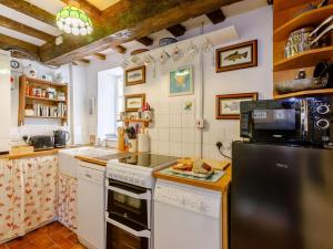 a kitchen with a refrigerator and a stove top oven at 2 Bed in Lechlade oc-40192 in Langford +13 photos