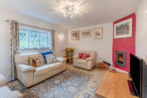 a living room with two couches and a red wall at 2 Bed in Woofferton oc-b29941 in Woofferton