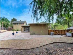 a house with a large yard with a fence at A master suite with own kitchenette and bath in Walnut Creek