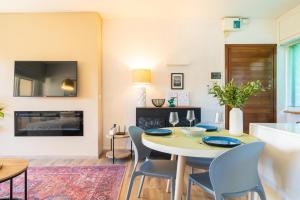 a living room with a table and chairs and a fireplace at Casa Sophie in Luino +25 photos