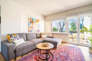 a living room with a couch and a table at Casa Sophie in Luino