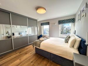 a large bedroom with a large bed and a bathroom at Central Haven Dingle in Dingle