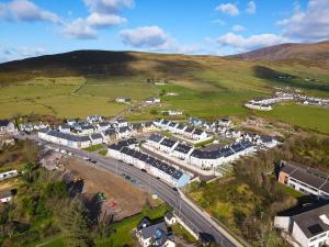 an aerial view of a village with houses and a road at Central Haven Dingle in Dingle