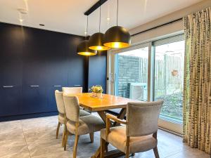 a dining room with a wooden table and chairs at Central Haven Dingle in Dingle