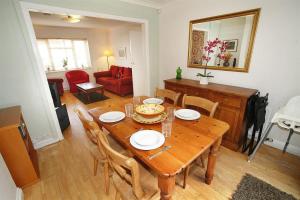 a dining room with a wooden table and chairs at 3 Bed in Mumbles oc-hh19 in The Mumbles +14 photos