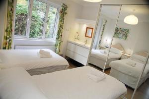 a small room with two beds and a mirror at 3 Bed in Mumbles oc-hh19 in The Mumbles