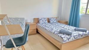 a bedroom with a bed and a desk and a chair at LANI house - stunning pool in Palm-Mar
