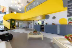 an office with a yellow staircase in a building at Guarujá Vivah in Guarujá