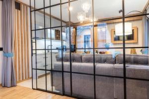 a living room with a large glass wall at Czerwone Wierchy Premium Apartment in Zakopane