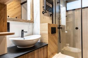 a bathroom with a sink and a shower at Czerwone Wierchy Premium Apartment in Zakopane