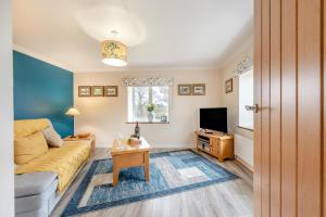 a living room with a couch and a tv at 1 Bed in Drefach oc-m30848 in Llanwenog