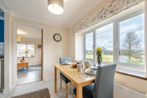 a dining room with a table and chairs and windows at 1 Bed in Drefach oc-m30848 in Llanwenog
