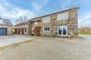 a large stone house with a driveway at 1 Bed in Drefach oc-m30848 in Llanwenog