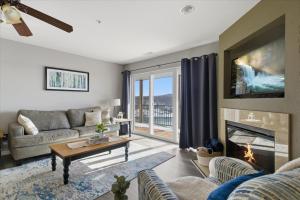 a living room with a couch and a fireplace at Serenity Now Retreat in Camdenton