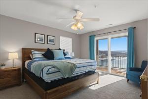 a bedroom with a bed and a ceiling fan at Serenity Now Retreat in Camdenton +53 photos
