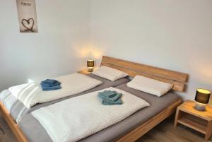 a bedroom with two beds with towels on them at Haus Dornröschen in Schweiburg