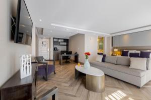 a living room with a couch and a table at Isaaya Hotel Boutique by WTC in Mexico City +79 photos