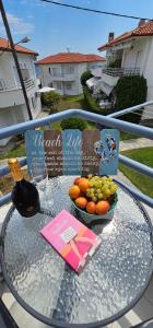 a glass table with a bowl of fruit on a balcony at Kalybeach Studio in Kalives Poligirou +23 photos