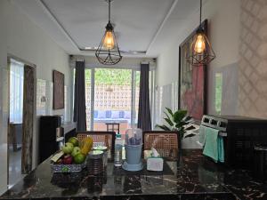 a kitchen with a table with fruit on it at Rumah Risa in Tanah Lot