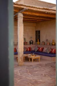 a living room with a couch and a table at Muma Lodge in Bouihat