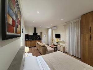 a hotel room with a bed and a living room at Vila Nikollaj in Kamëz
