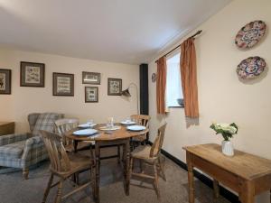 a living room with a wooden table and chairs at 2 Bed in Cockermouth oc-sz136 in Lorton