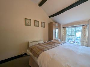 a bedroom with a large white bed and a window at 2 Bed in Cockermouth oc-sz136 in Lorton