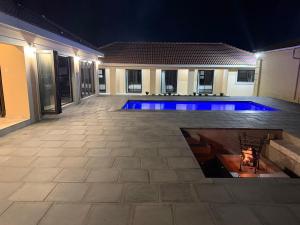 a swimming pool in the middle of a house at night at M & N Guest House in Ermelo