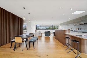 a kitchen and dining room with a table and chairs at Rubus St Residence by Sothebys Luxury Rental Homes in Wanaka