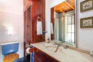 a bathroom with a sink and a blue toilet at Hotel La Posada del Valle in Tepoztlán +47 photos