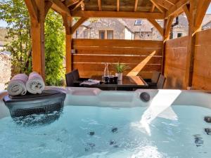 a hot tub in a patio with a table at 3 Bed in Bakewell oc-90384 in Bakewell