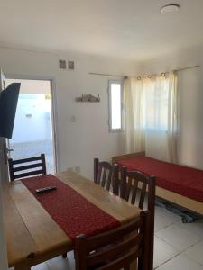 a dining room with a table and a table and chairs at Tafi Apart in Sarmiento