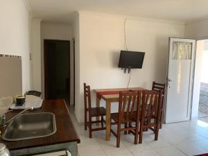 a kitchen and dining room with a table and a television at Tafi Apart in Sarmiento