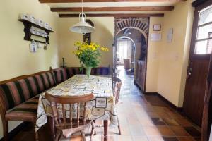 a dining room table with a vase of flowers on it at Hof ter Wallen in Zoutleeuw +18 photos