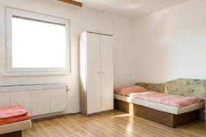 a small room with a bed and a window at Kechnec - Seňa in Kehnec